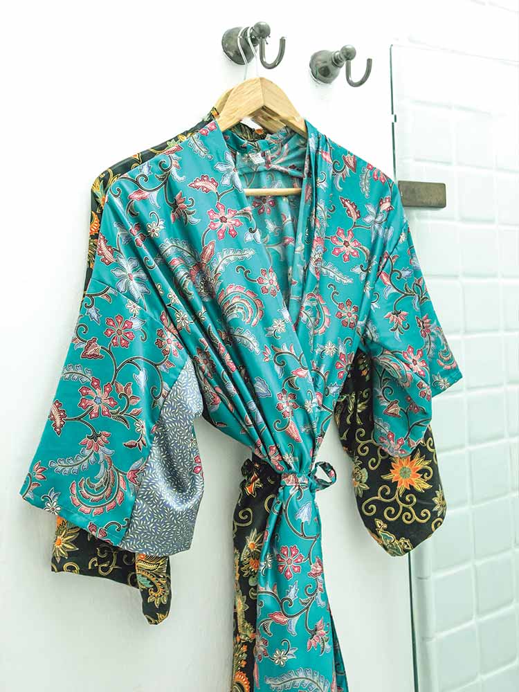 Turquoise dressing gown hanging in bathroom of Hummingbird Suite in Amarla Hotel Cartagena