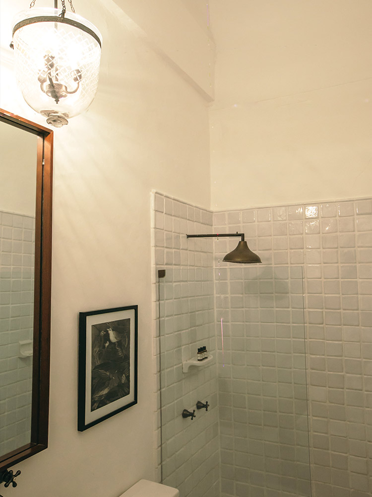 Shower with white tiles in bathroom of Maria Mulata in Amarla boutique hotel Cartagena