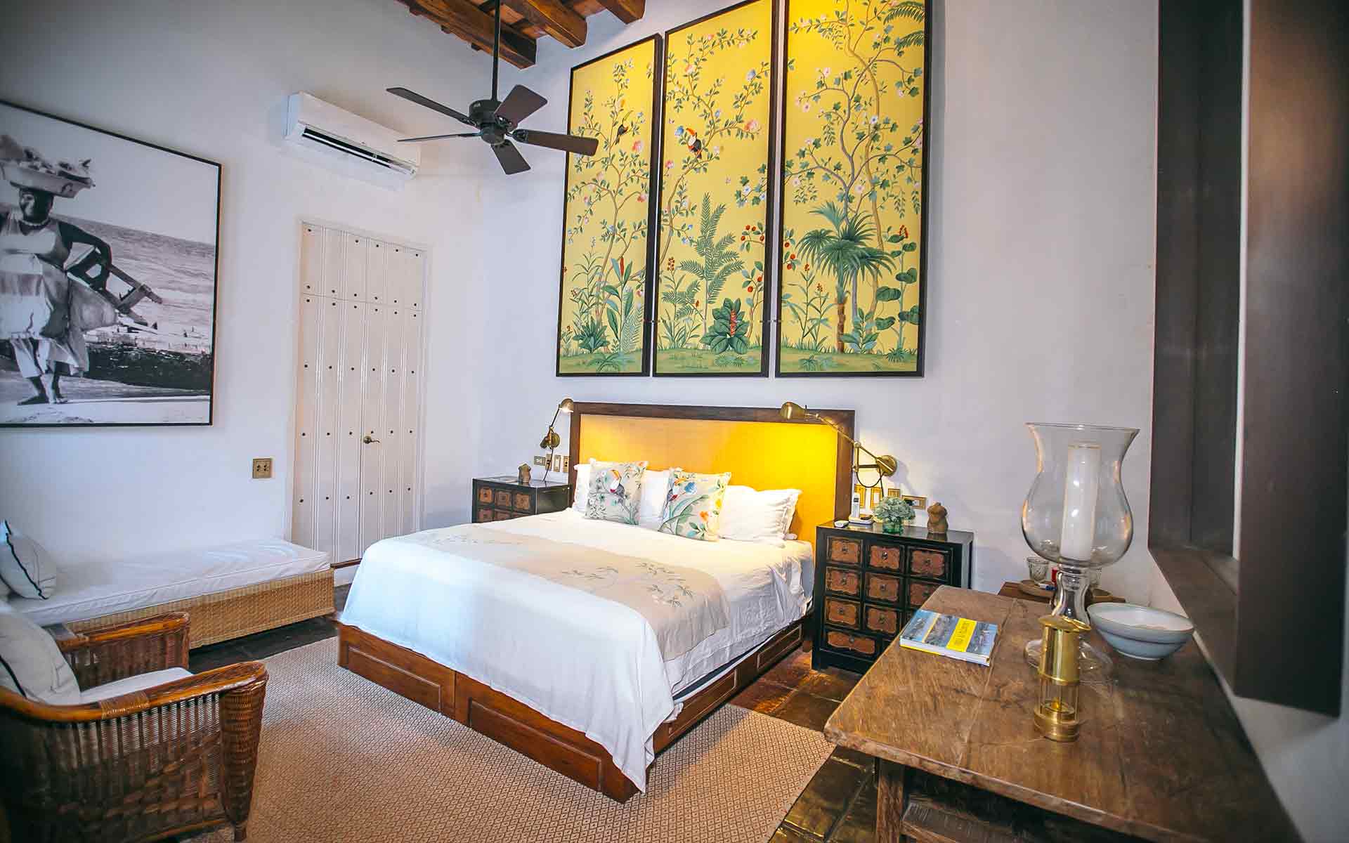 Toucan bedroom with huge triple yellow artworks at Amarla Boutique Hotel, one of the best places to stay in Cartagena Colombia