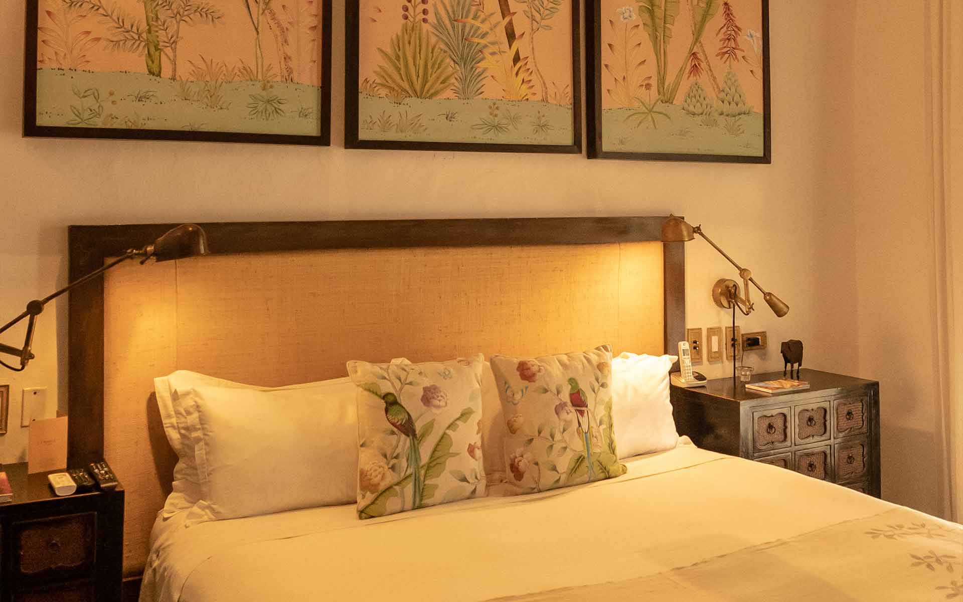 Quetzal Room with king size bed and De Gournay panels and pillows depicting tropical botanical scenes